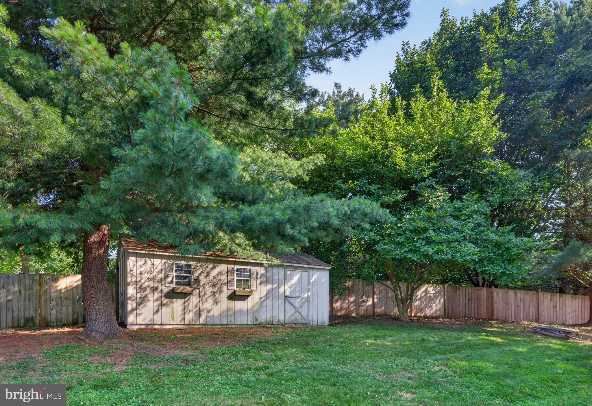 2634 Pleasant Hill Road Hanover, PA 17331 - Photo 14 of 52 Charming shed nestled in lush greenery.