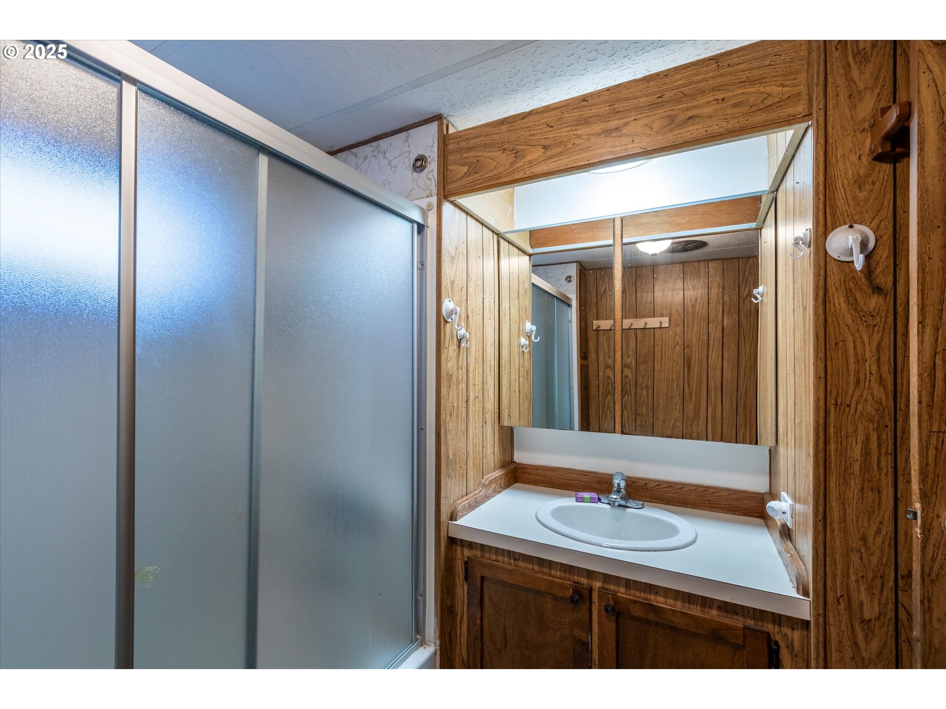 125 North 4th Street Lakeside, OR 97449 - Photo 22 of 38 a bathroom with a sink and a mirror