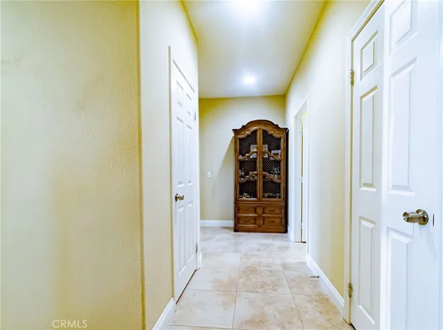a spacious bedroom with a bed and wooden floor