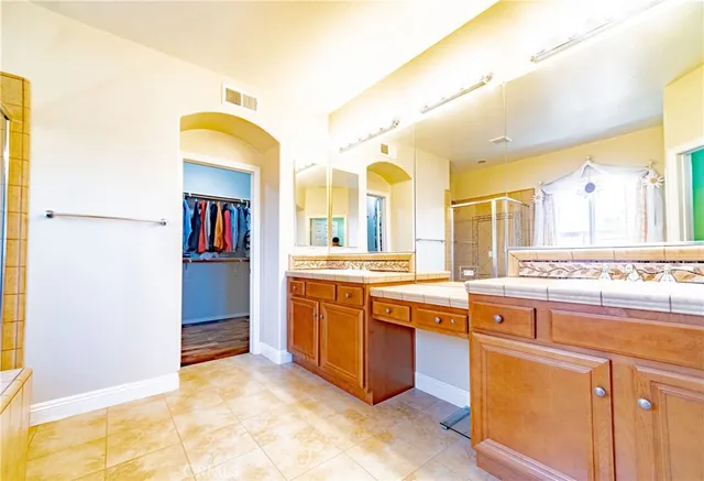 a view of walk in closet with clothes and shoes
