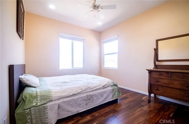 a bathroom with a sink a toilet a mirror and shower