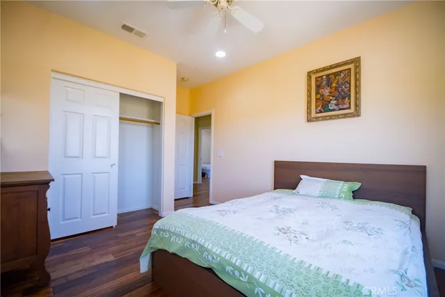 a bedroom with bed and a chandelier