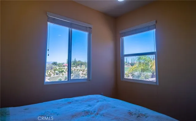 a bedroom with a bed and a view of bedroom