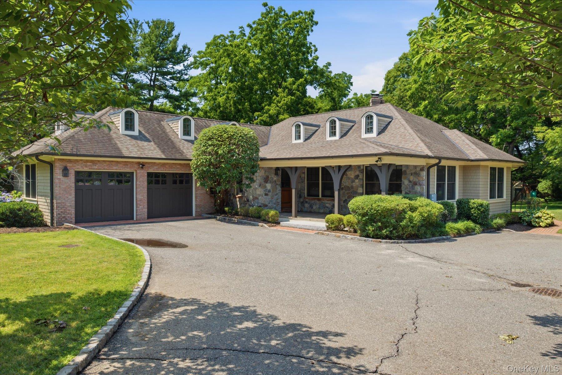 134 Sandy Hollow Road Northport, NY 11768 - Photo 2 of 28 Belgian block accents, cedar shingles, and Pennsylvania river rock create lasting curb appeal
