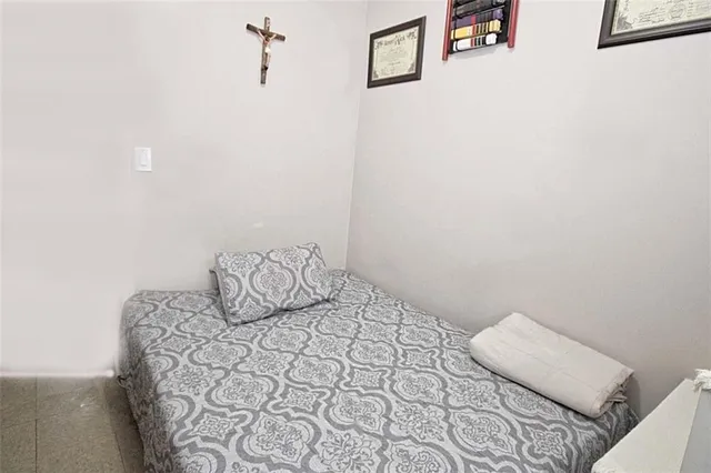 a bedroom with a bed and a night stand