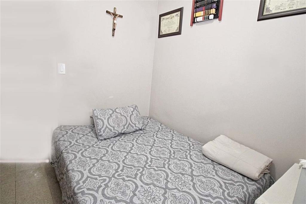 6018 4th Avenue Brooklyn, NY 11220 - Photo 12 of 15 a bedroom with a bed and a night stand