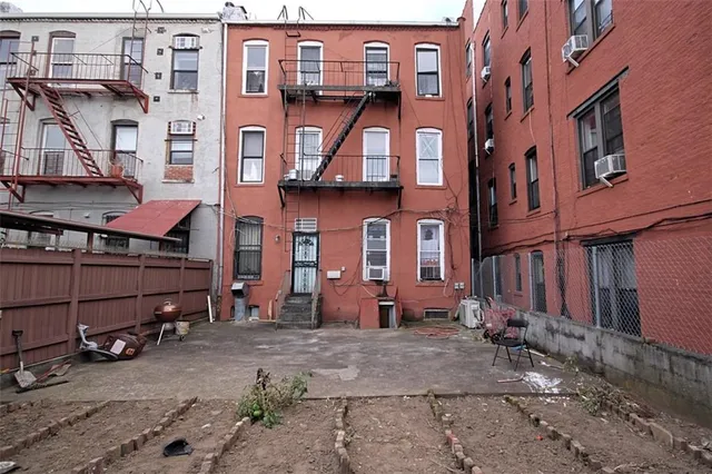 a view of a brick building with many windows