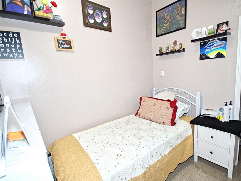 6018 4th Avenue Brooklyn, NY 11220 - Photo 10 of 15 a bedroom with a bed and painting on the wall