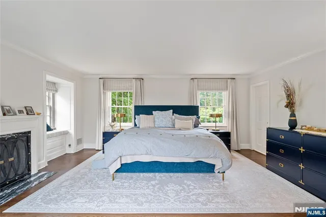 a spacious bedroom with a large bed and a dresser