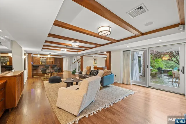 a view of a livingroom with furniture wooden floor and windows