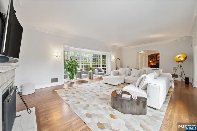 a living room with furniture large window and flat screen tv
