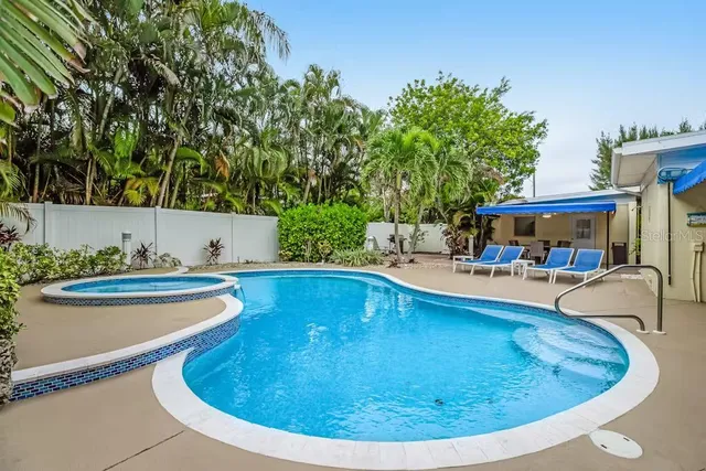 a view of a swimming pool with lounge chair