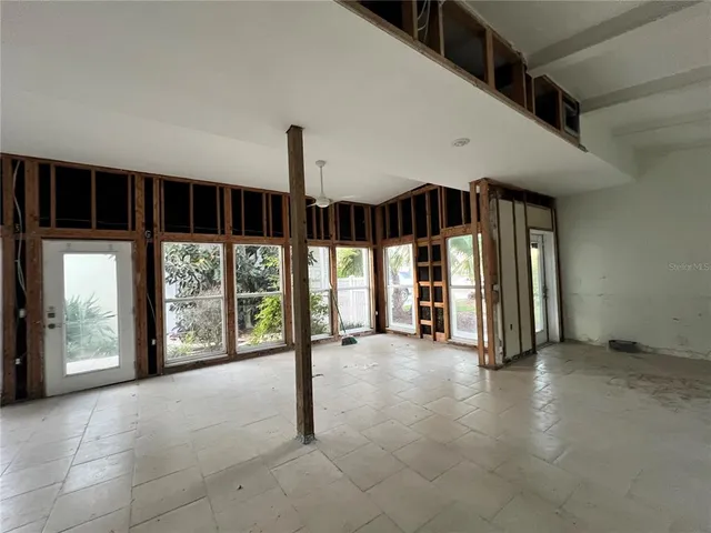 a view of a big room with windows and chandelier