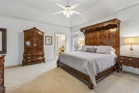 a spacious bedroom with a bed and a walk in closet