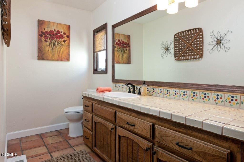 5000 Dolphin Way Oxnard, CA 93035 - Photo 30 of 56 a bathroom with a sink a toilet and mirror