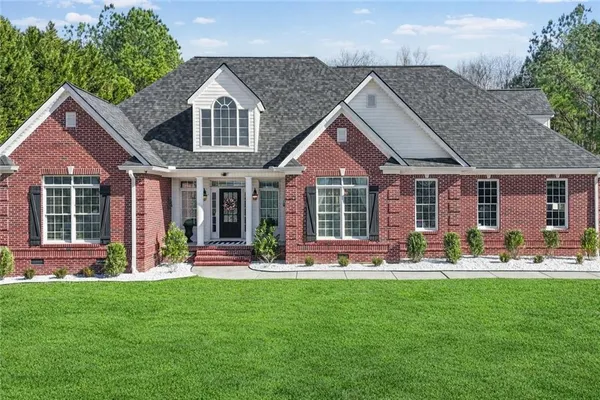 a front view of a house with sitting area and garden