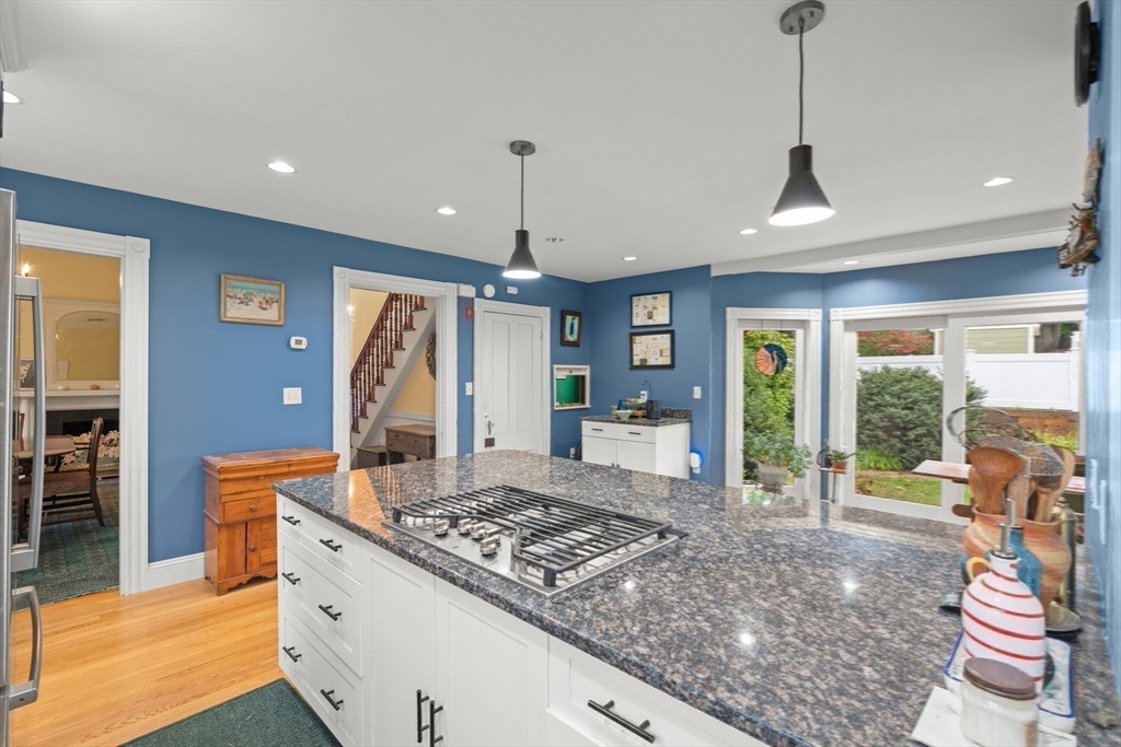 600 East Street Dedham, MA 02026 - Photo 15 of 39 a kitchen with a stove a sink a counter space and a dining table