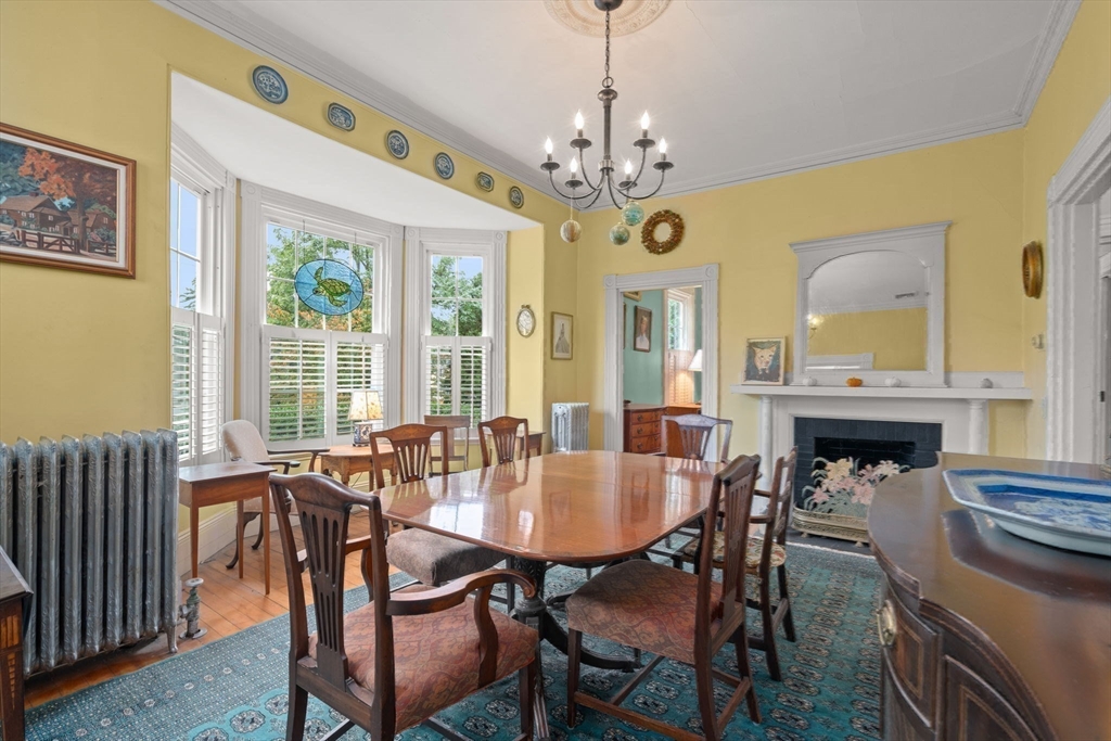 600 East Street Dedham, MA 02026 - Photo 18 of 39 a view of a dining room with furniture a chandelier and wooden floor