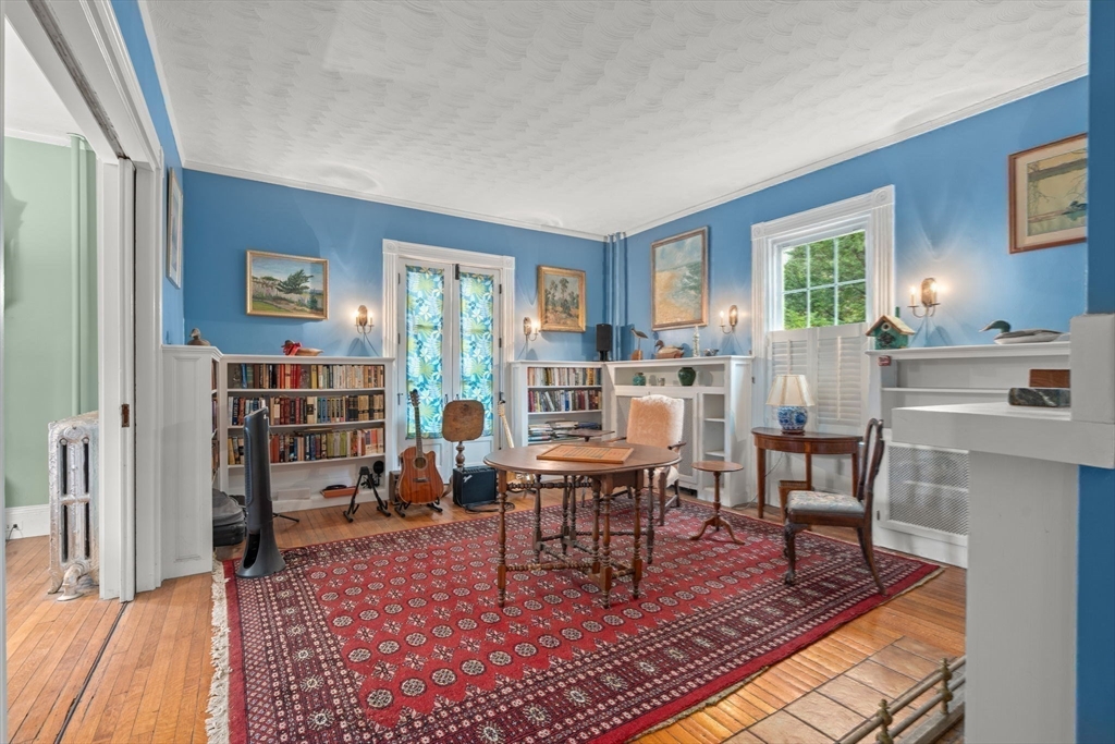 600 East Street Dedham, MA 02026 - Photo 21 of 39 a living room with furniture a rug and a bookshelf
