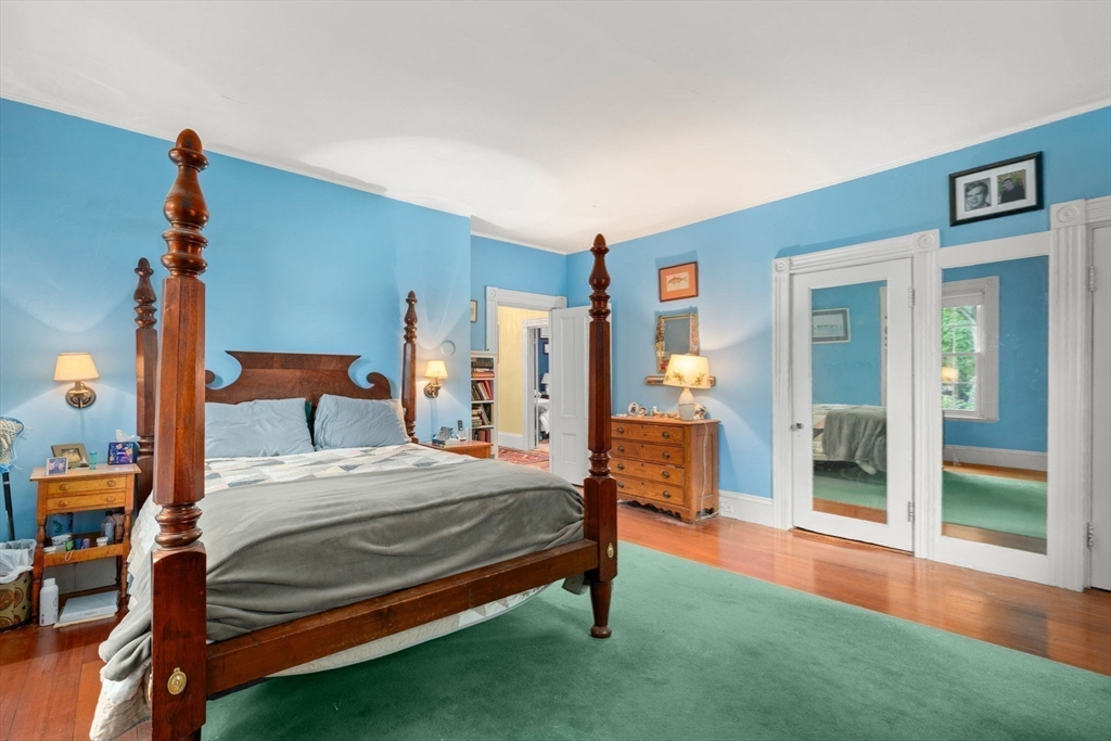 600 East Street Dedham, MA 02026 - Photo 28 of 39 a bedroom with a bed and a chandelier