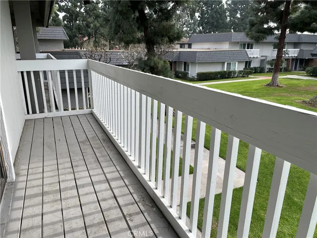 a view of a brick house with a large trees
