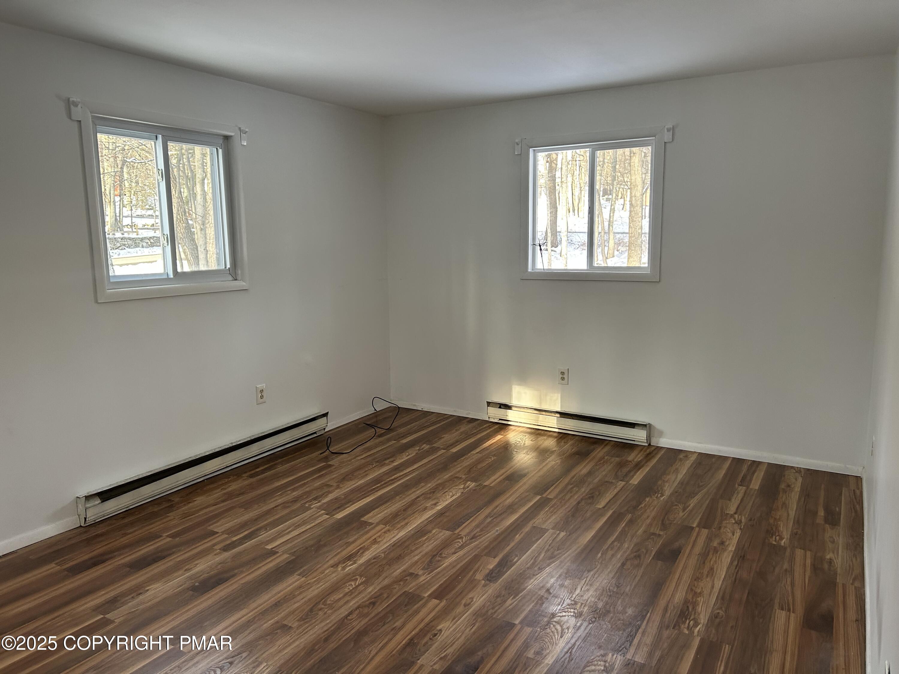 107 Davis Circle Bushkill, PA 18324 - Photo 24 of 35 a view of empty room with wooden floor and fan