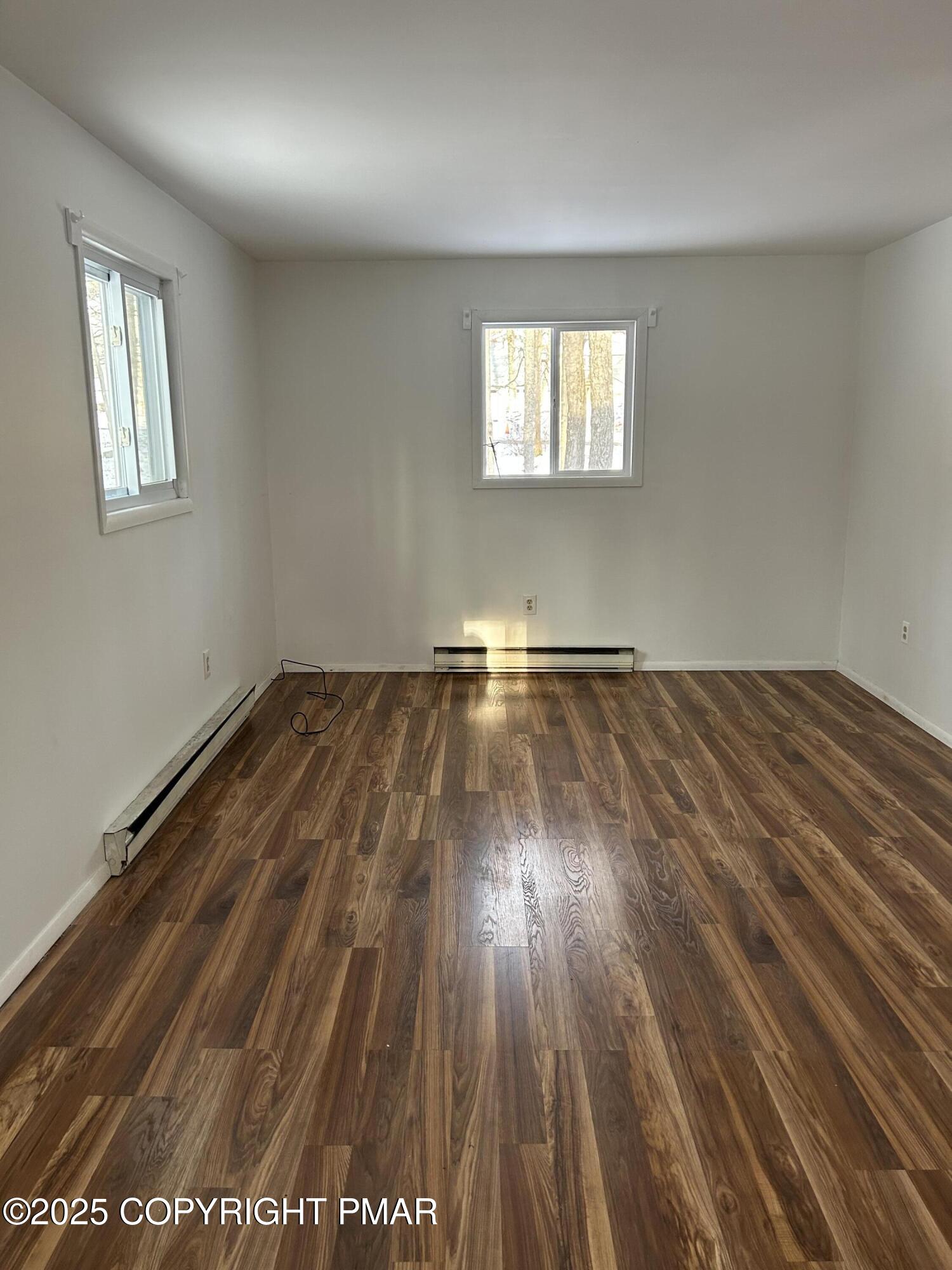 107 Davis Circle Bushkill, PA 18324 - Photo 25 of 35 an empty room with wooden floor and windows