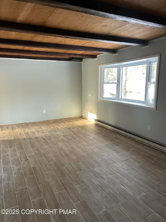 a view of an empty room with a window