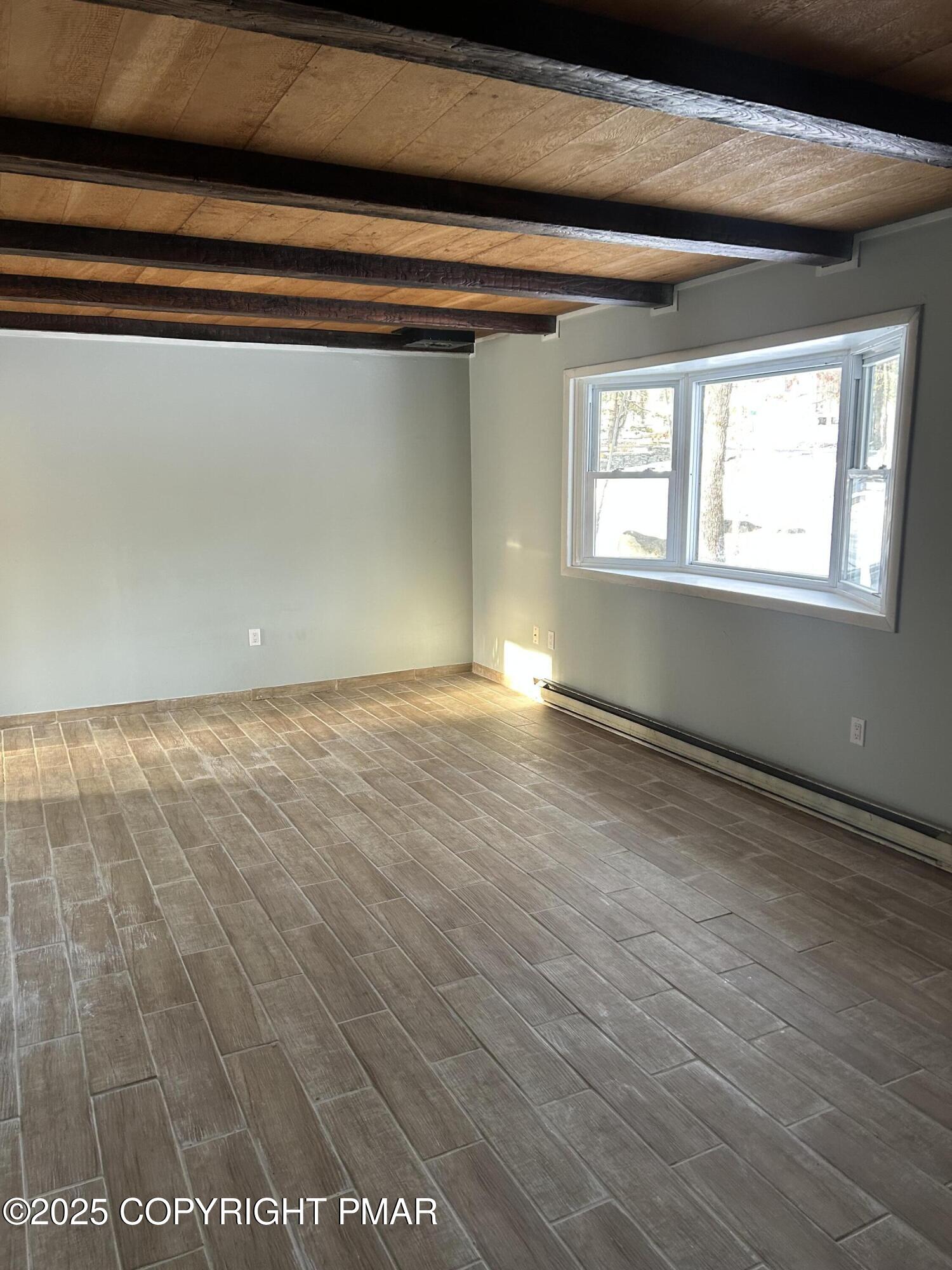 107 Davis Circle Bushkill, PA 18324 - Photo 3 of 35 a view of an empty room with wooden floor and a window
