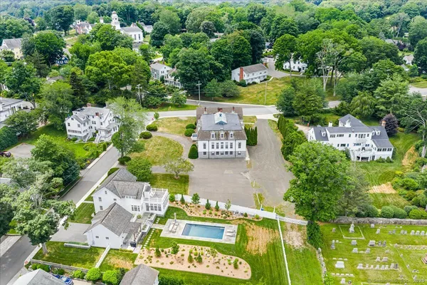 an aerial view of a house with swimming pool outdoor seating and yard