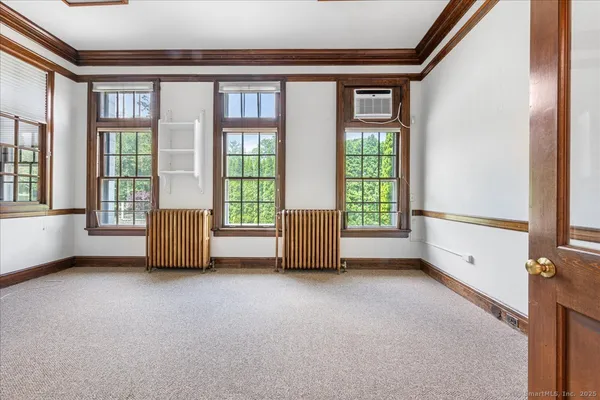 an empty room with furniture and a fireplace