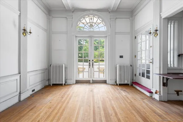 a view of a livingroom with wooden floor and a fireplace