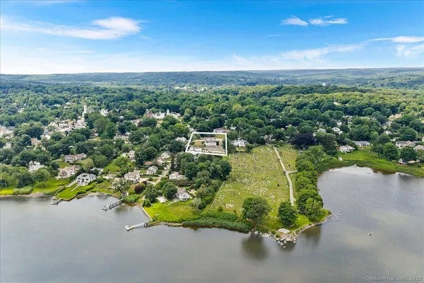 a view of empty room with wooden floor and fireplace