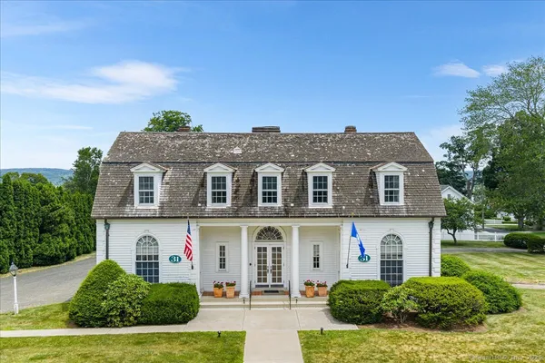 an aerial view of a house with a garden and trees