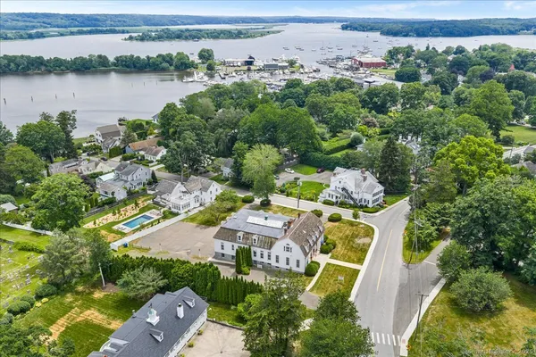 an aerial view of residential houses with outdoor space and lake view