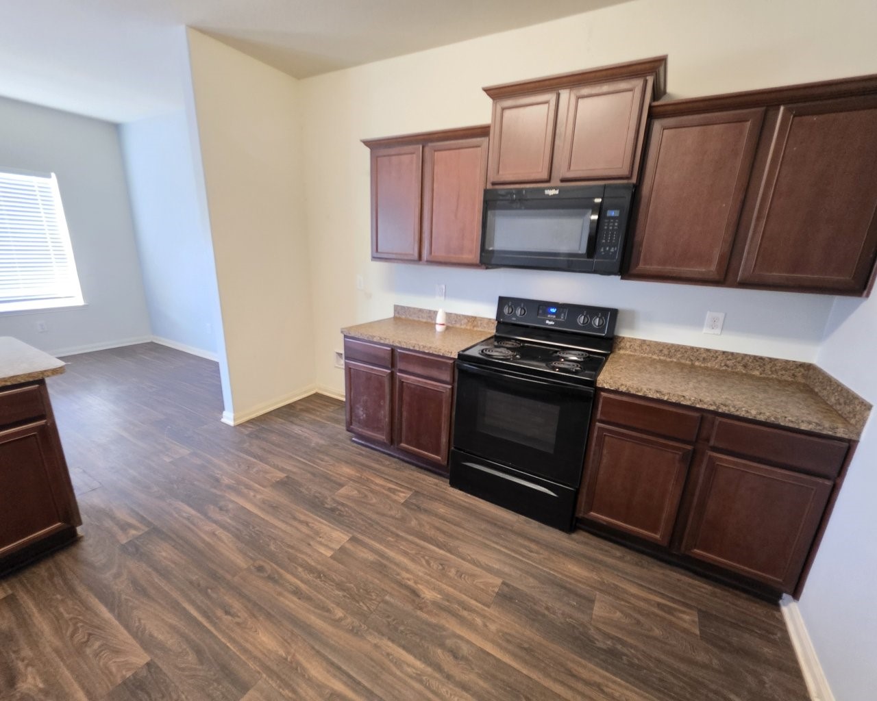 2709 Calypso Place La Marque, TX 77568 - Photo 2 of 21 a kitchen with wooden floors and black appliances