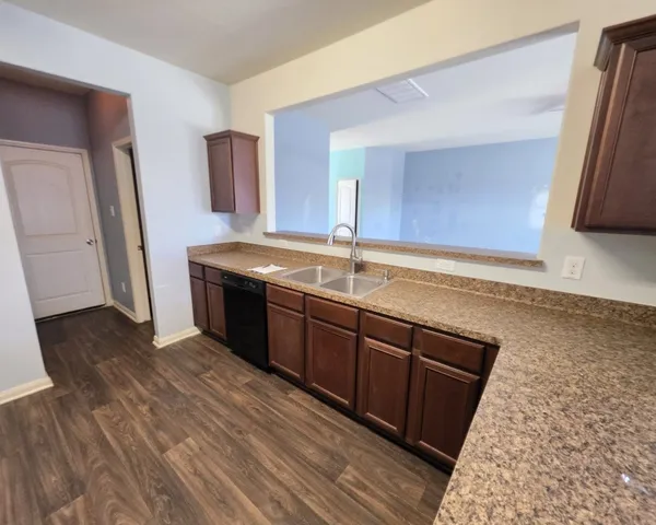 a kitchen with a sink and a stove top oven