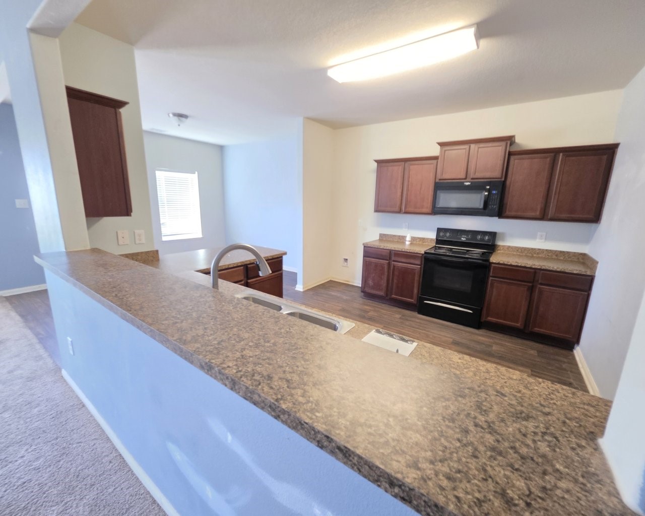 2709 Calypso Place La Marque, TX 77568 - Photo 4 of 21 a kitchen with kitchen island granite countertop a sink stove and refrigerator