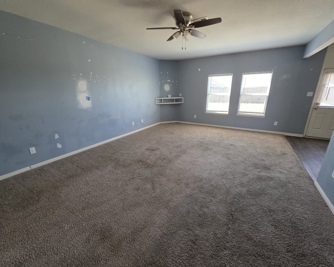 2709 Calypso Place La Marque, TX 77568 - Photo 6 of 21 a view of an empty room with a window and a kitchen