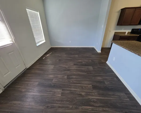 a view of a kitchen with wooden floor and a sink