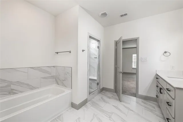 a bathroom with a bathtub and a shower