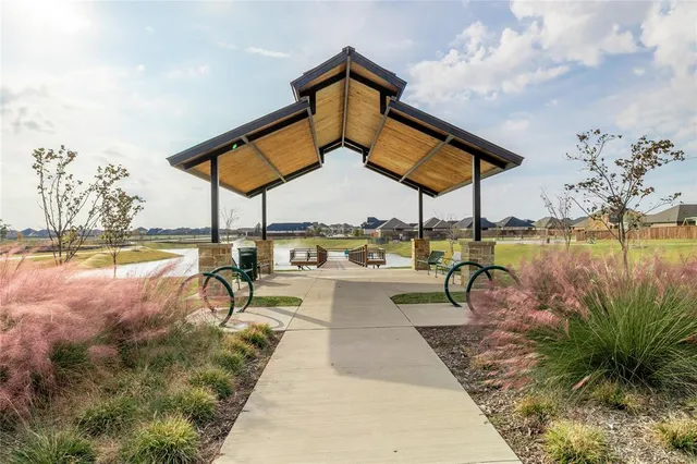 a view of a swimming pool with a table and chairs under an umbrella