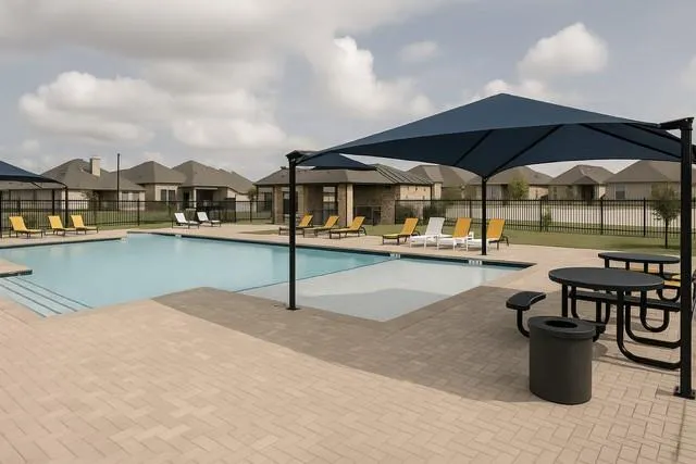 a view of a swimming pool with a table and chairs under an umbrella