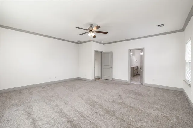 a view of an empty room with a ceiling fan