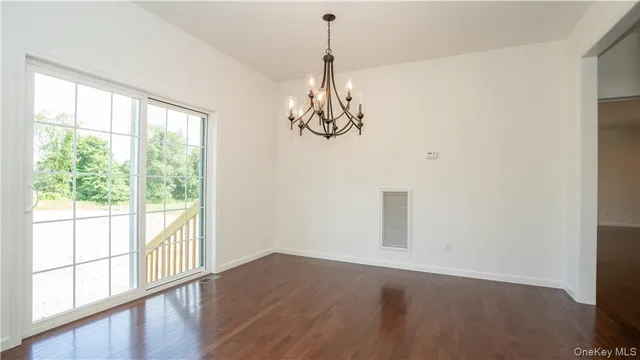 a view of a room with wooden floor and windows