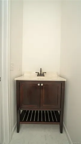 a white toilet sitting next to a white wall