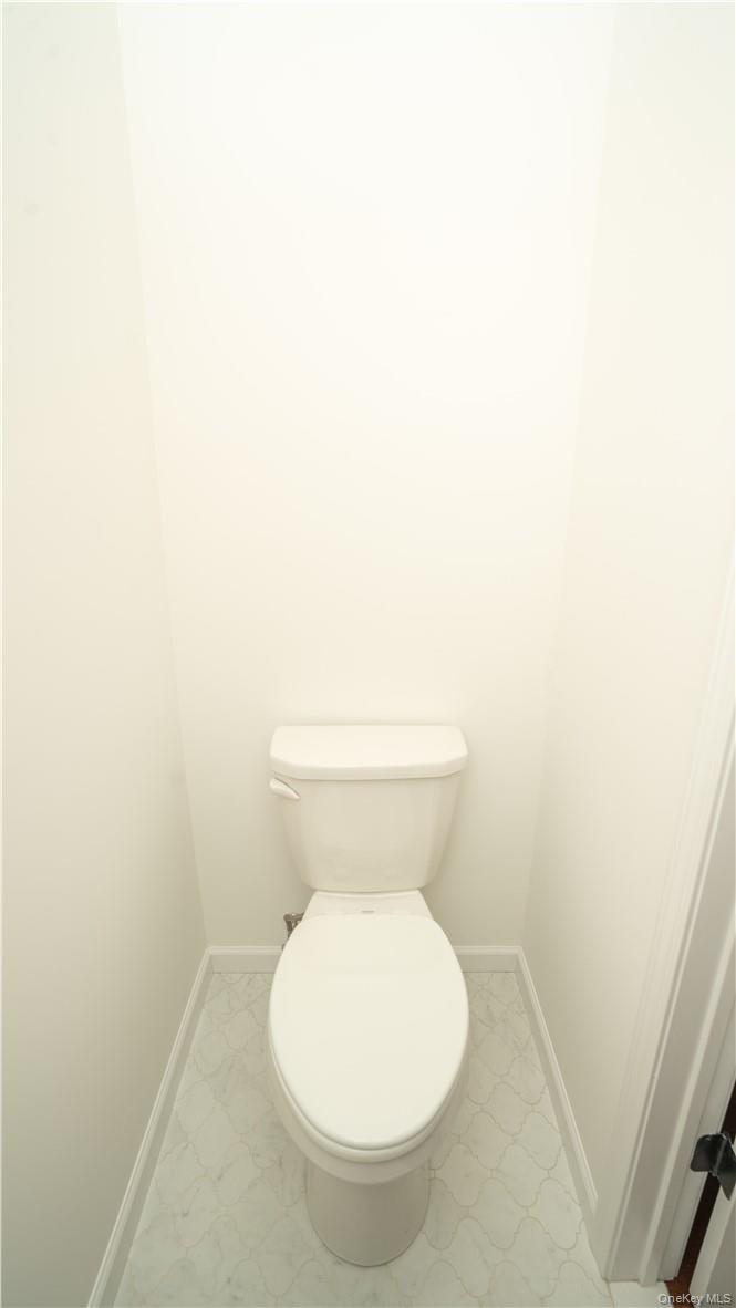 475 Du Bois Road Wallkill, NY 12589 - Photo 16 of 35 a white toilet sitting next to a white wall