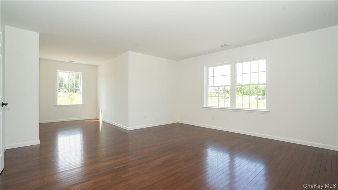 475 Du Bois Road Wallkill, NY 12589 - Photo 17 of 35 an empty room with wooden floor and windows