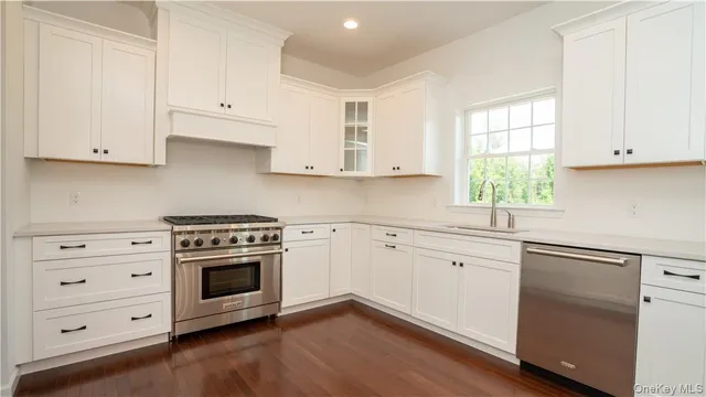 a kitchen with cabinets appliances and a window
