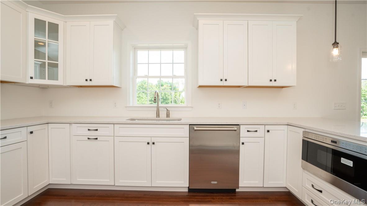475 Du Bois Road Wallkill, NY 12589 - Photo 6 of 35 a kitchen with granite countertop white cabinets and white appliances